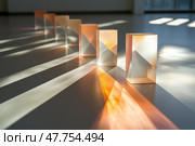 Light refracting through transparent rectangular prisms creating colorful shadows. Стоковое AI-изображение, AI-художник Юрий Поздников / Фотобанк Лори