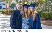 A proud family gathers for graduation day, celebrating together with bright smiles and traditional caps and gowns in a festive atmosphere. Стоковое AI-изображение, AI-художник Данила Большаков / Фотобанк Лори