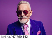 Carefree extravagant elderly man in sunglasses and a blue suit on purple background, created with Generative AI. Стоковое AI-изображение, AI-художник Данила Большаков / Фотобанк Лори