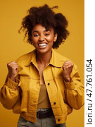 Positive contented curly haired African-American girl raising her fists, celebrating achievement triumph against yellow background. Стоковое AI-изображение, AI-художник Данила Большаков / Фотобанк Лори