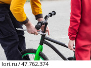 Father and son fixing a bike with wrench. Стоковое фото, фотограф Елена Добрынина / Фотобанк Лори