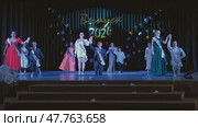 Berdovka, Belarus - June 17, 2024: Elegant students celebrating their graduation ceremony on a stage, wearing sashes and formal attire. Редакционное фото, фотограф Mikhail Davidovich / Фотобанк Лори