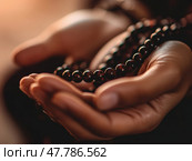 Close-up of hands holding prayer beads (misbaha), soft light, Ramadan setting, focus on spirituality. Стоковое AI-изображение, AI-художник Надежда Рыбальченко / Фотобанк Лори