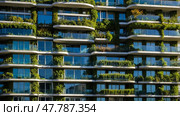 Modern building with green terraces showcasing sustainable architecture in an urban setting. Стоковое AI-изображение, AI-художник Сергей Толмачёв / Фотобанк Лори