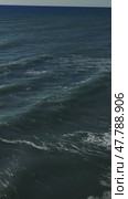 Gentle waves cascading over sandy beach, sunlight sparkling on rippling water surface, creating peaceful coastal scenery. Стоковое видео, видеограф ILIA GOROKHOV / Фотобанк Лори