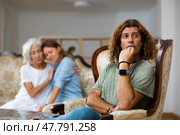 Upset man dont speaking after discord with mother and wife. Стоковое фото, фотограф Яков Филимонов / Фотобанк Лори