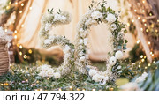 Floral number fifty celebrating golden anniversary or birthday party. Стоковое AI-изображение, AI-художник Юрий Поздников / Фотобанк Лори