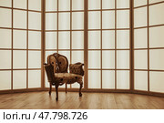 Elegant Vintage Chair Positioned Indoors With Bright, Expansive Windows Creating a Serene Atmosphere. Стоковое фото, фотограф Aleksandr Golubev / Фотобанк Лори