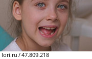 Little girl performs articulation exercises for mouth, concept of speech disorders, correction. Dentist, doctor examines oral cavity of small patient, length of frenum of the tongue. Motion footage. Стоковое видео, видеограф Ирина Михайличенко / Фотобанк Лори