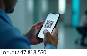 A smartphone in the hands of a man against the background of a medical corridor. Матричный QR код. Стоковое AI-изображение, AI-художник Терехова Марина / Фотобанк Лори