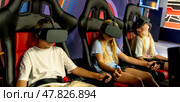 Children on 5D attraction in virtual reality glasses. Стоковое фото, фотограф Igor Skripachev / Фотобанк Лори