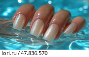 Beautiful gel nails submerged in clear blue water at a serene setting. Красивые гелевые ногти, погруженные в прозрачную голубую воду в безмятежной обстановке. Стоковое AI-изображение, AI-художник Katsiaryna Repich / Фотобанк Лори