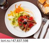 Traditional Catalan cuisine. Escalivada from vegetables baked in oven until tender served with anchovy fillets on plate. Стоковое фото, фотограф Яков Филимонов / Фотобанк Лори