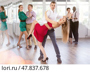Young man and woman practicing waltz in dancing studio. Стоковое фото, фотограф Яков Филимонов / Фотобанк Лори