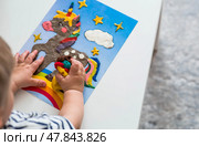 A little boy is playing with plasticine. Fine motor skills-developing games for children. The kid makes a horse. Useful games for child development. Стоковое фото, фотограф Photojuli / Фотобанк Лори