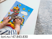 A little boy is playing with plasticine. Fine motor skills-developing games for children. The kid makes a horse. Useful games for child development. Стоковое фото, фотограф Photojuli / Фотобанк Лори
