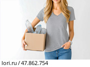 A Girl in plain colors T-shirt carries a box of recyclables. Стоковое AI-изображение, AI-художник Ирина Ручушкина / Фотобанк Лори