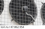 Industrial fans starting and rotating behind protective grid. Стоковое видео, видеограф Андрей Знаменский / Фотобанк Лори