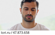 Sad depressed man in depression and bad mood, looking down and touching forehead, loneliness and pain concept. Fighting with yourself, meditation. Стоковое AI-видео, аниматор ALLA YURTAYEVA / Фотобанк Лори