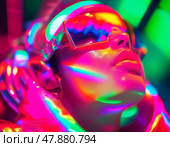 A person immersed in radiant psychedelic colors wears reflective sunglasses. The vibrant lights create a surreal atmosphere, enhancing the trance experience. Generative AI. Стоковое AI-изображение, AI-художник Юлия Петровская / Фотобанк Лори