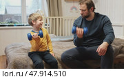 Caucasian bearded strong father with one child boy doing push ups on floor in living room. Family fitness gym at home. Sporty dad and son piggy back having fun exercise. Funny sport with kid. 4k video. Стоковое видео, видеограф Марина Демидюк / Фотобанк Лори