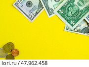 Dollars and euro coins on a yellow background, background with copy space. Стоковое фото, фотограф Юлия Николаева / Фотобанк Лори