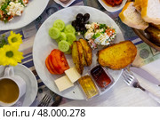 Delicious breakfast with vegetables, salad, cheese, olives and bread. Стоковое фото, фотограф Яков Филимонов / Фотобанк Лори