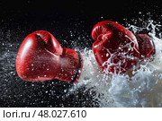 two boxing gloves clashing in a test. Стоковое фото, фотограф Anastasy Yarmolovich / Фотобанк Лори