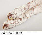 Close-up of spiced spanish fuet sausages at white background. Стоковое фото, фотограф Яков Филимонов / Фотобанк Лори