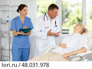 Male beautician, together with a nurse, examines the face of an mature woman and plans facelift procedures. Стоковое фото, фотограф Яков Филимонов / Фотобанк Лори