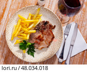 Pork chop with French fries on a plate. Стоковое фото, фотограф Яков Филимонов / Фотобанк Лори