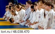 Moscow, Russia, April 24, 2025: Children practice martial arts with a coach in the gym, sambo, judo, aikido. Редакционное фото, фотограф Igor Skripachev / Фотобанк Лори