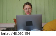 Teen girl school student wear headphones watching online webinar, talking through webcam looking at laptop. Teenager conducting video conference on computer at home, chatting online with friends. 4K. Стоковое видео, видеограф Марина Демидюк / Фотобанк Лори