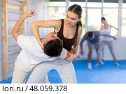 Young girl applying throwing technique on her opponent in sports hall. Стоковое фото, фотограф Яков Филимонов / Фотобанк Лори