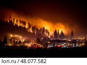 A large-scale forest fire raging in a small town, flames engulfing trees and smoke rising into the sky, silhouettes of houses are visible against the background of the fire. Стоковое AI-изображение, AI-художник Алексей Кузнецов / Фотобанк Лори