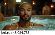 A man enjoys a tranquil moment in a hot tub with bubbling water, surrounded by steaming ambiance and fellow spa-goers in the evening. Стоковое AI-изображение, AI-художник Данила Большаков / Фотобанк Лори