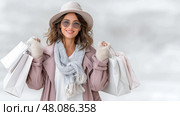 Stylish Young Woman Excited with Shopping Bags, Store Discounts and Promotions. Модная молодая счастливая девушка  с покупками, сделанными во время шопинга. Скидки и акции в магазинах. Стоковое AI-изображение, AI-художник Katsiaryna Repich / Фотобанк Лори