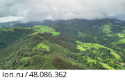 Lush, Vibrant Green Hills Beneath a Brooding Cloudy Sky Stunning Aerial Landscape. Стоковое видео, видеограф Vladimir Vintonjak / Фотобанк Лори