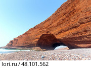 Spectacular natural red arch on atlantic ocean coast, Legzira (or Gzira) beach. Red archs on atlantic ocean coast. Sidi Ifni, Morocco, Africa (2024 год). Стоковое фото, фотограф Евгений Ткачёв / Фотобанк Лори