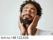 Man enjoying self-care routine while smiling in a bright indoor setting. Мужчина наслаждается процедурой ухода за собой и улыбается в светлом помещении. Стоковое AI-изображение, AI-художник Katsiaryna Repich / Фотобанк Лори