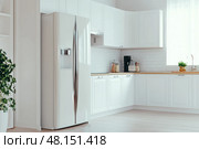 Modern trendy kitchen design with white cabinets. Subway tile backsplash, marble countertop. No brands or labels. Neutral contemporary design. Simply furniture with utensils, crockery, refrigerator. Стоковое AI-изображение, AI-художник Марина Демидюк / Фотобанк Лори