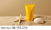Yellow Sunscreen cream tube, starfishes and seashells on a sand top view. Cosmetic mockup. Sunblock lotion on sandy beach background. Summer vacation care concept, sun screen product, spf uv protect. Стоковое AI-изображение, AI-художник Марина Демидюк / Фотобанк Лори
