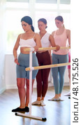 Group of enthusiastic young female ballet students focused on mastering graceful Demi rond de jambe par terre exercise at barre in mirrored well-lit choreography studio. Стоковое видео, видеограф Яков Филимонов / Фотобанк Лори