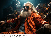 Weird carefree hippy shaggy mature dude with a gray beard and sunglasses in orange clothes is sitting on a pile of boxes and trunks and suitcases illuminated from above. Стоковое AI-изображение, AI-художник Данила Большаков / Фотобанк Лори