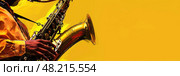 A musician energetically plays the saxophone, creating vibrant music in a vivid atmosphere. Стоковое AI-изображение, AI-художник Данила Большаков / Фотобанк Лори