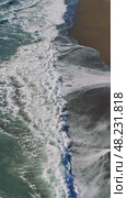 Turquoise ocean waves rolling, gently crashing onto sandy shoreline, revealing rhythmic marine energy and serene coastal landscape. Стоковое видео, видеограф ILIA GOROKHOV / Фотобанк Лори