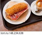 Sandwiches bocadillo from fresh baguette filled with sliced ham. Spanish food. Стоковое фото, фотограф Яков Филимонов / Фотобанк Лори