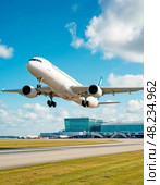 The take-off of a passenger plane, in the distance, the building of a modern airport. Стоковое AI-изображение, AI-художник Сергей Елизарьев / Фотобанк Лори