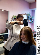 Visiting the Hair Salon for a Refreshing New Look and Pampering Experience. Стоковое фото, фотограф Aleksandr Golubev / Фотобанк Лори