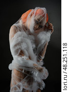 Red woman artistically entangled in a delicate net trap. Стоковое фото, фотограф Гурьянов Андрей / Фотобанк Лори